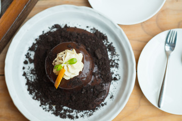 Chocolate lava cake with orange slice and whipping cream