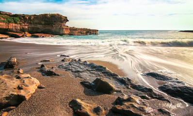 Long exposure of waves flowing over a rocky beach at Pancake Rocks on New Zealand's south isalnd.