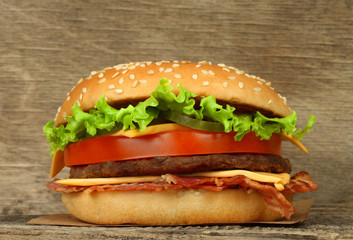 Big hamburger on wooden background