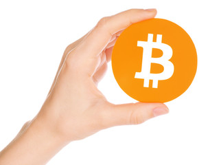 Hand holds Bitcoin on white background