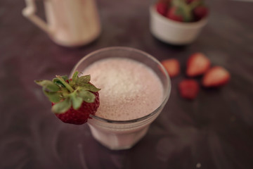 Fresh strawberry smoothie or milkshake and berries on purple background. Summer vibes. Healthy Eating concept