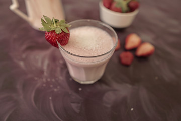 Fresh strawberry smoothie or milkshake and berries on purple background. Summer vibes. Healthy Eating concept