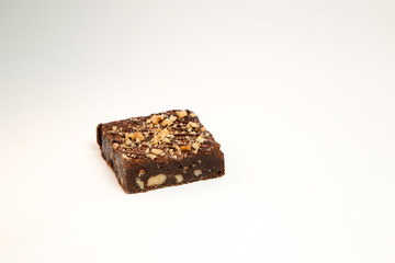 Slice of hazelnut brownie cake isolated on white background, no shadow