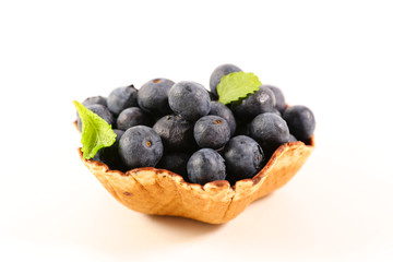 blueberry in biscuit bowl isolated on white background