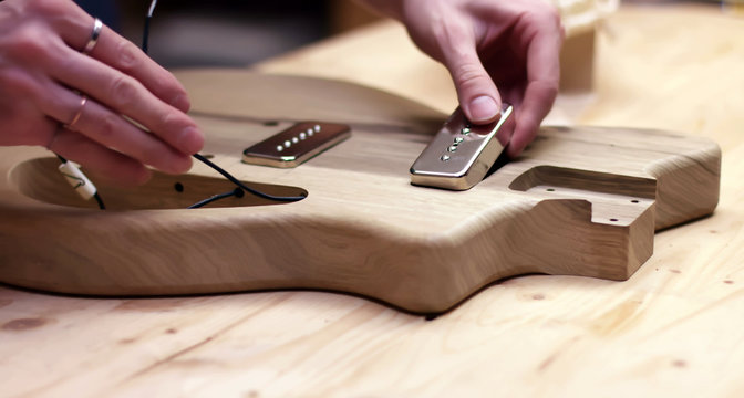 Making a guitar, driling hole in wood body of guitar