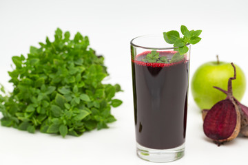 Red beetroot detox smoothie with basil and apple juice. Healthy eating and weight loss concept.