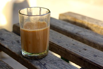 glass of Chai on wooden table