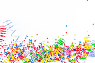 Colorful assorted confetti with serpentine on white