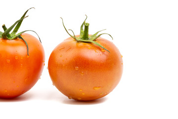 Tomato closeup on white background. Selective focus and crop fragment