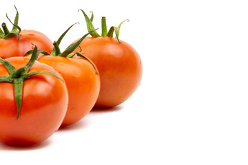 Tomato closeup on white background. Selective focus and crop fragment
