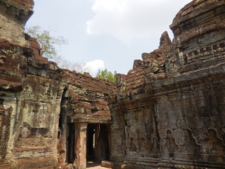 Fototapeta premium The ruin of the ancient stone structures temple and its graceful reliefs, Cambodia