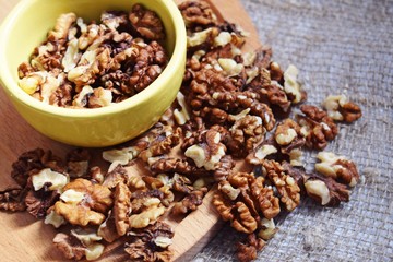 Useful walnuts on a burlap and wood background.