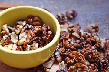 Useful walnuts on a burlap and wood background.