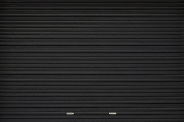 black shutter door with stainless steel holder. grunge black metal foldable door background and...