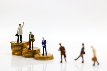 Fototapeta premium Miniature people: Businessmen standing on coins stack, Finance, investment and growth in business concept.