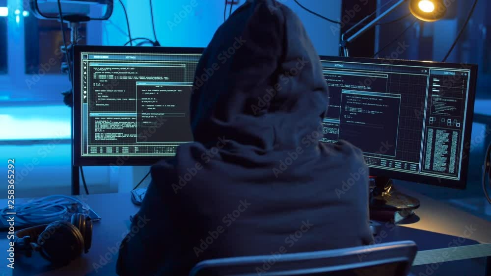 Poster cybercrime, hacking and technology concept - hacker in dark room creating code or using computer vir