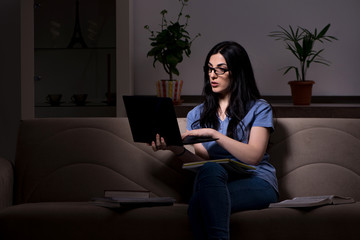 Obraz premium Young female student preparing for exams at night time