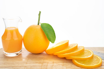 Orange juice and oranges with leaves