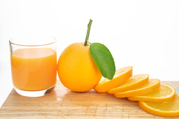 Orange juice and oranges with leaves