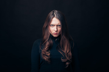 Portrait of angry upset woman isolated on black background