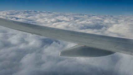 Traveling by air. Plane wing in flight. Beautiful sky and wonderful clouds