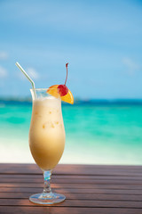 cocunut cocktail and sea background on clear sky day
