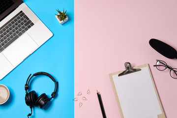 Music or podcast background with headphones, microphone, coffee and laptop on pink table, flat lay....