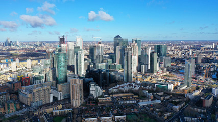 Naklejka na ściany i meble Aerial bird's eye panoramic photo taken by drone of iconic Canary Wharf skyscraper complex and business district, Isle of Dogs, London, United Kingdom