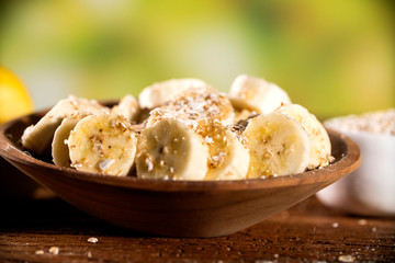 oatmeal with banana and honey in bowl, close-up, horizontal