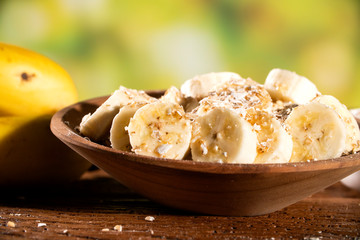 oatmeal with banana and honey in bowl, close-up, horizontal