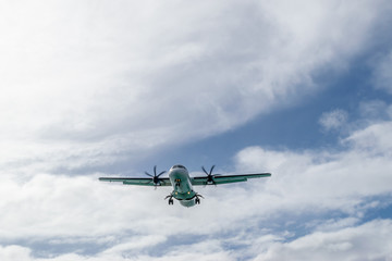 An ATR 72-600 turboprop-powered aircraft with wheels down preparing to land