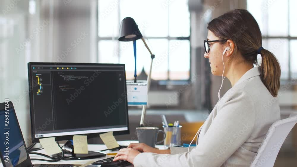Poster business, programming and technology concept - female programmer in earphones working with script on