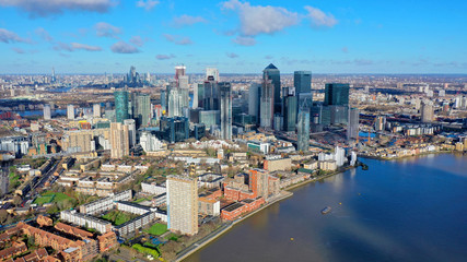 Fototapeta na wymiar Aerial bird's eye view panoramic drone photo of Greenwich park with views to Canary Wharf and University of Greenwich with beautiful cloudy sky, Isle of Dogs, London, United Kingdom
