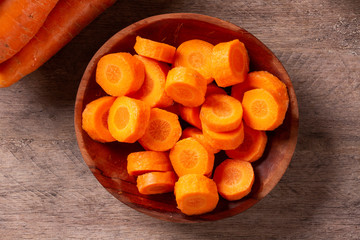 Carrots and carrot sliced on wooden table. Selective focus.