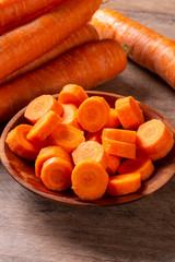 Carrots and carrot sliced on wooden table. Selective focus.