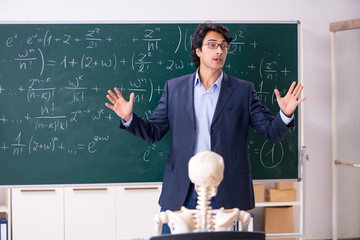 Young male math teacher and student skeleton