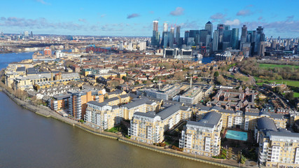 Obraz na płótnie Canvas Aerial bird's eye panoramic photo taken by drone of iconic Canary Wharf skyscraper complex and business district, Isle of Dogs, London, United Kingdom