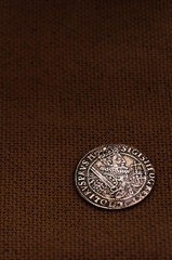 Silver coin on linen background