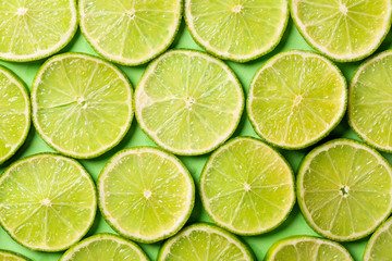 Fototapeta na wymiar A slices of fresh juicy green lemons. Texture background, pattern