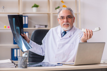 Aged male doctor radiologist in the clinic