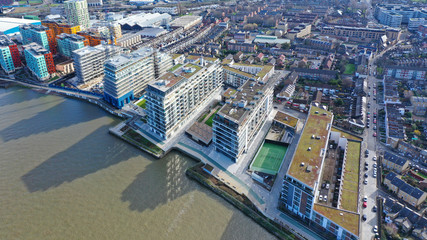 Aerial drone night shot from iconic Canary Wharf skyscrapers business area, Isle of Dogs, London,...