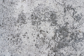 Macro texture of peeled paint on a white concrete wall.