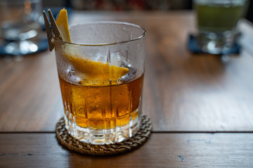 Old fashioned cocktail served in a whiskey glass at the restaurant. Copy space