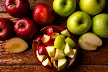 Ripe red and green apples on table close up