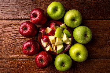 Ripe red and green apples on table close up