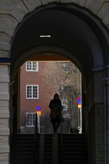 Stockholm, Sweden Pedestrians on Vanadisvägen walking on the Tre Liljor Square and portico.