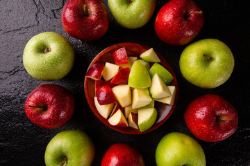 Ripe red and green apples on table close up