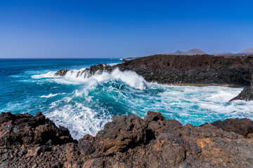 Spain, Lanzarote, Giant breaking wave flooding into los hervideros cove