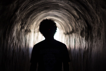 man walking in tunnel
