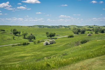 Niobrara state park, Nebraska in spring. Beautiful green landscape and blue sky with cumulus clouds.